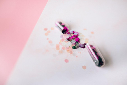 Pink substance inside a transparent capsule